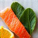 Fresh salmon, dark leafy greens, and ginger, known for anti-inflammatory properties